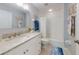 Bright bathroom features a granite vanity, framed mirror, and a shower-tub combination at 5300 S Atlantic Ave # 3-504, New Smyrna Beach, FL 32169