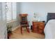 Inviting bedroom showcasing a rocking chair and shuttered window, creating a relaxing ambiance at 5300 S Atlantic Ave # 3-504, New Smyrna Beach, FL 32169
