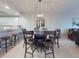 Dining room with a dark table and seating for six, along with a stunning light fixture at 5300 S Atlantic Ave # 3-504, New Smyrna Beach, FL 32169