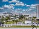 Exterior view with lush palm trees lining the street with the ocean in the distance, offering tropical tranquility at 5300 S Atlantic Ave # 3-504, New Smyrna Beach, FL 32169