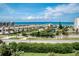 Residential beachfront neighborhood view with palm trees, lush greenery, and ocean views at 5300 S Atlantic Ave # 3-504, New Smyrna Beach, FL 32169