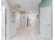 Bright hallway with multiple doors leading to different rooms, showcasing a clean and spacious design at 5300 S Atlantic Ave # 3-504, New Smyrna Beach, FL 32169