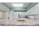 Kitchen with bright countertops, white cabinets, and modern appliances, perfect for cooking and entertaining at 5300 S Atlantic Ave # 3-504, New Smyrna Beach, FL 32169