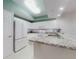 Bright kitchen with white cabinets and stainless steel appliances and granite countertops at 5300 S Atlantic Ave # 3-504, New Smyrna Beach, FL 32169
