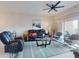 Cozy living room featuring comfortable seating, a ceiling fan, and access to outdoor spaces at 5300 S Atlantic Ave # 3-504, New Smyrna Beach, FL 32169