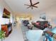 Inviting living room showcasing a leather sofa set, ceiling fan, and an open layout to the dining area and kitchen at 5300 S Atlantic Ave # 3-504, New Smyrna Beach, FL 32169