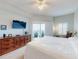 Serene main bedroom with a dresser, a ceiling fan, and a private balcony with outdoor chairs at 5300 S Atlantic Ave # 3-504, New Smyrna Beach, FL 32169