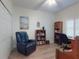 Home office with accent painting, wood bookshelves, and chair at 5300 S Atlantic Ave # 3-504, New Smyrna Beach, FL 32169