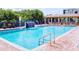 Large community swimming pool with waterfall feature, poolside seating, and a nearby pavilion at 5300 S Atlantic Ave # 3-504, New Smyrna Beach, FL 32169