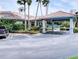 Exterior view of the recreation building with parking and lush landscaping at 5300 S Atlantic Ave # 3-504, New Smyrna Beach, FL 32169