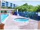 Relaxing spa area adjacent to pool with lounge chairs and lush greenery at 5300 S Atlantic Ave # 3-504, New Smyrna Beach, FL 32169