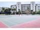 Enjoy a game of tennis at this community court with tropical landscaping and nearby condominium building at 5300 S Atlantic Ave # 3-504, New Smyrna Beach, FL 32169