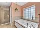 Relaxing bathroom with a soaking tub and a glass-enclosed shower at 610 Renner Rd, Port Orange, FL 32127