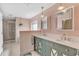 Elegant bathroom with dual sinks, a large mirror, and a walk-in shower at 610 Renner Rd, Port Orange, FL 32127