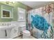 Charming bathroom with pedestal sink and nautical shower curtain at 610 Renner Rd, Port Orange, FL 32127