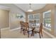 Bright dining area with glass table and wooden chairs, near pool access at 610 Renner Rd, Port Orange, FL 32127