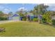 Blue house with metal roof, three-car garage, and landscaped yard at 610 Renner Rd, Port Orange, FL 32127