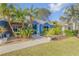 Landscaped front yard with tropical plants and walkway at 610 Renner Rd, Port Orange, FL 32127