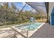 Inviting screened pool with steps and a spacious deck at 610 Renner Rd, Port Orange, FL 32127