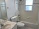 Bathroom with a sink, toilet, and bathtub-shower combo, all in a bright, tiled space at 621 Middlebury Loop, New Smyrna Beach, FL 32168