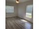 Bedroom with wood-look floors and bright, naturally lit windows at 621 Middlebury Loop, New Smyrna Beach, FL 32168