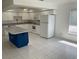 Bright kitchen featuring white cabinets, appliances, and an island perfect for meal prep at 621 Middlebury Loop, New Smyrna Beach, FL 32168