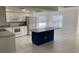 Spacious kitchen with white cabinets, white appliances, and large center island at 621 Middlebury Loop, New Smyrna Beach, FL 32168