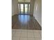 Bright living room featuring wood floors and glass doors leading to the backyard at 621 Middlebury Loop, New Smyrna Beach, FL 32168