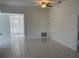 Open-concept living room featuring tiled floors and a ceiling fan at 621 Middlebury Loop, New Smyrna Beach, FL 32168