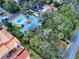 Aerial shot showcasing a backyard pool, trees, and well-maintained landscaping at 634 N Riverside Dr, New Smyrna Beach, FL 32168