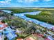 Waterway aerial view showcasing docks, lush foliage, and beautiful skies at 634 N Riverside Dr, New Smyrna Beach, FL 32168