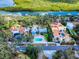 Aerial view of the property, showing the pool, landscaping, and proximity to waterfront views and community at 634 N Riverside Dr, New Smyrna Beach, FL 32168