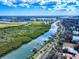 Beautiful aerial view of the river, surrounding landscape, and nearby waterfront community at 634 N Riverside Dr, New Smyrna Beach, FL 32168