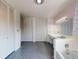 Bathroom featuring a sink with vintage fixtures, tiled walls, and blue tile floor at 634 N Riverside Dr, New Smyrna Beach, FL 32168