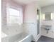 Bathroom featuring a tub with flamingo curtains, vintage fixtures, and blue tile floors at 634 N Riverside Dr, New Smyrna Beach, FL 32168