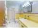 Bathroom featuring yellow tile, and an updated vanity and mirror at 634 N Riverside Dr, New Smyrna Beach, FL 32168