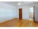 Bedroom featuring hardwood floors, ceiling fan, and access to en suite bathroom at 634 N Riverside Dr, New Smyrna Beach, FL 32168