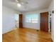 Bedroom featuring hardwood floors, ceiling fan, and access to en suite bathroom at 634 N Riverside Dr, New Smyrna Beach, FL 32168