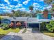 Stylish exterior of a well-maintained home featuring a carport, landscaped front yard, and inviting curb appeal at 634 N Riverside Dr, New Smyrna Beach, FL 32168