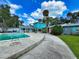 The unique exterior features a private pool, concrete walkway and well maintained tropical landscaping at 634 N Riverside Dr, New Smyrna Beach, FL 32168