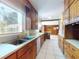 A bright kitchen featuring a stainless steel sink, wood cabinets, and white appliances for a functional design at 634 N Riverside Dr, New Smyrna Beach, FL 32168