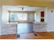 Living room with red tile floor, ample windows, and stone dividers at 634 N Riverside Dr, New Smyrna Beach, FL 32168