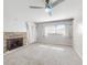 Living room with stone fireplace, ceiling fan, and neutral carpet at 634 N Riverside Dr, New Smyrna Beach, FL 32168