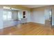 Living room with hardwood floors, featuring partial stone walls into the kitchen and entry at 634 N Riverside Dr, New Smyrna Beach, FL 32168