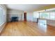 Spacious living room featuring wood floors and a stone fireplace, with a view of the backyard at 634 N Riverside Dr, New Smyrna Beach, FL 32168