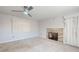 Living room with stone fireplace, ceiling fan, neutral carpet and curtains at 634 N Riverside Dr, New Smyrna Beach, FL 32168