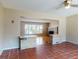 Inviting living room features red tile, ceiling fan, and stone column accents at 634 N Riverside Dr, New Smyrna Beach, FL 32168