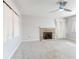 Bright living room featuring a ceiling fan, fireplace, and neutral carpet at 634 N Riverside Dr, New Smyrna Beach, FL 32168