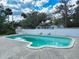 Large private backyard pool offers a refreshing escape, surrounded by tropical foliage at 634 N Riverside Dr, New Smyrna Beach, FL 32168