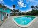 Refreshing backyard pool featuring a spacious deck and lush landscaping, perfect for outdoor enjoyment at 634 N Riverside Dr, New Smyrna Beach, FL 32168